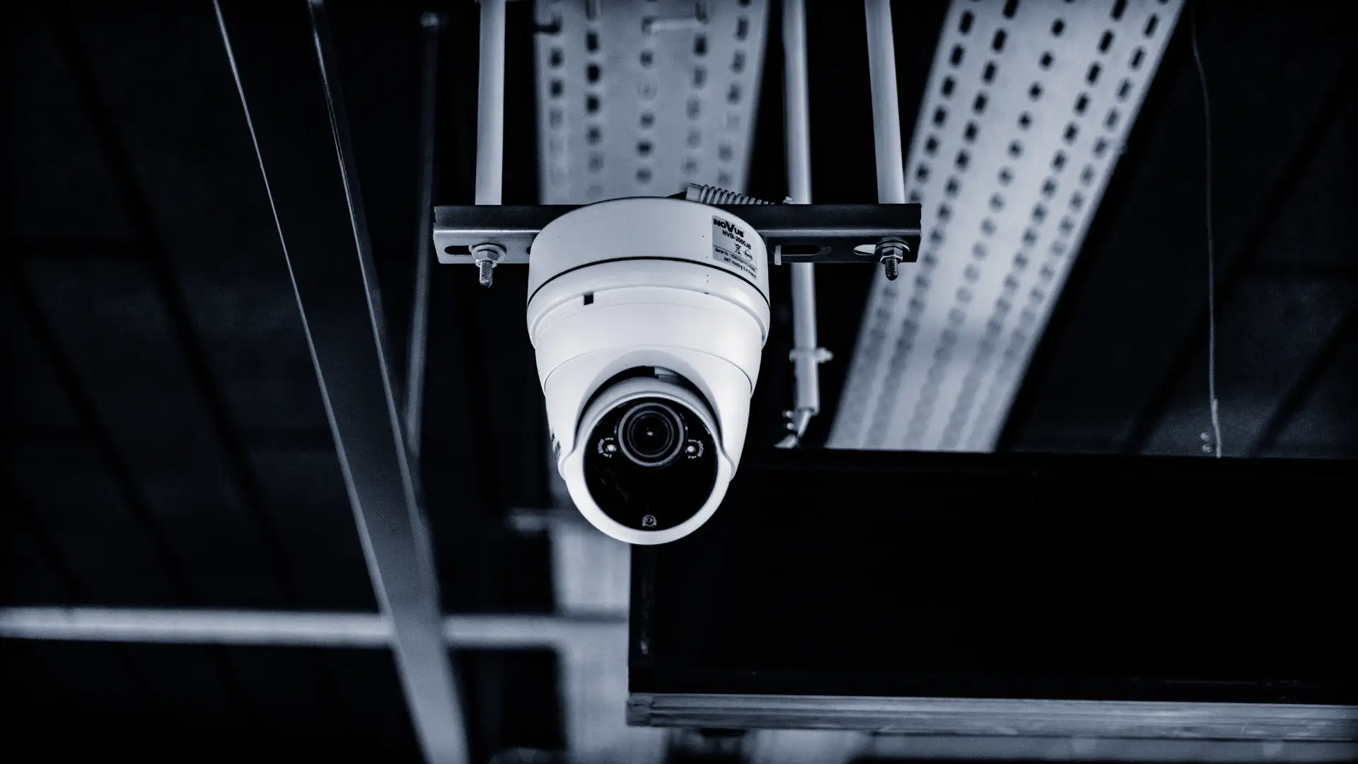 Security surveillance camera mounted on a ceiling.